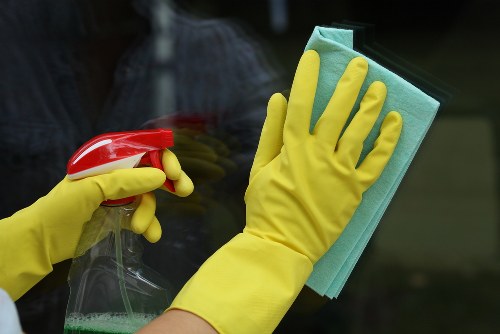 Cleaning staff using protective measures during a carpet cleaning task