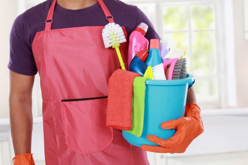 Carpet cleaning technician preparing equipment safely in a home